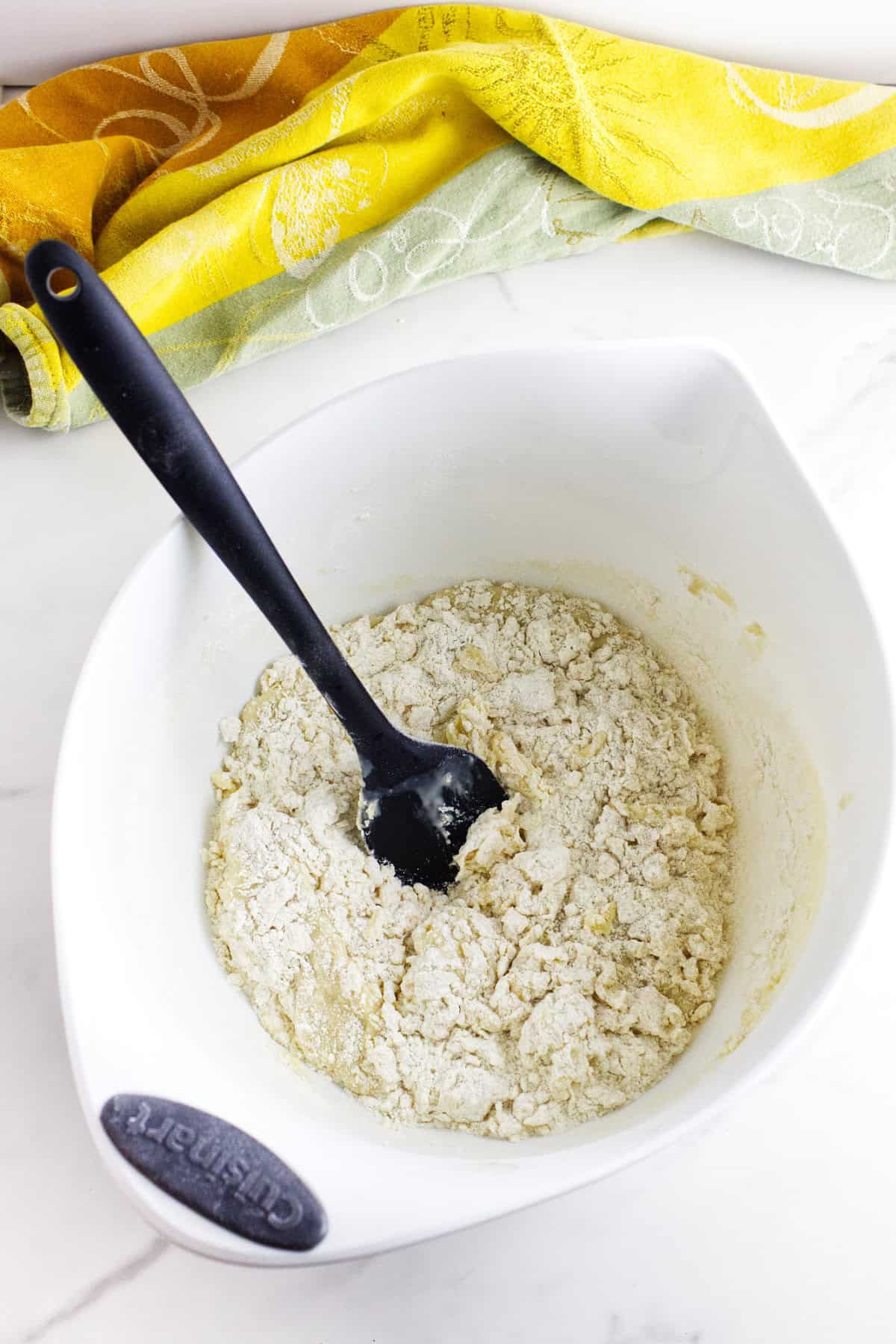 Smooth dough mixture forming in the bowl.