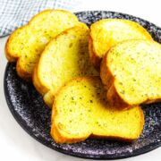 slices of toasted Texas toast french bread on a blue speckled platter.