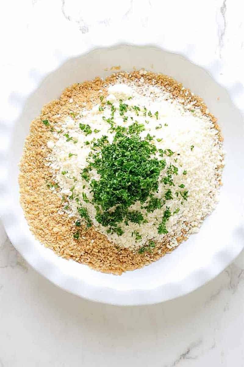 toasted bread crumbs, seasonings, flour, and parsley in a bowl.