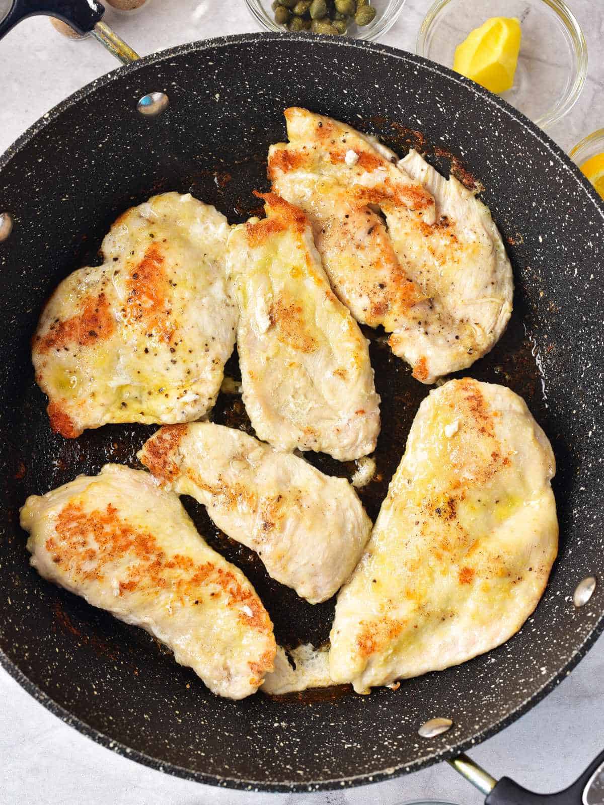browned chicken breast in a cast iron skillet.