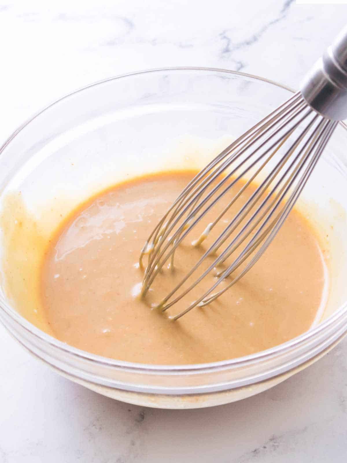 whisk in a bowl of blended sauce.