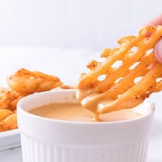 platter of waffle fries and a bowl of Chick-Fil-A dipping sauce.