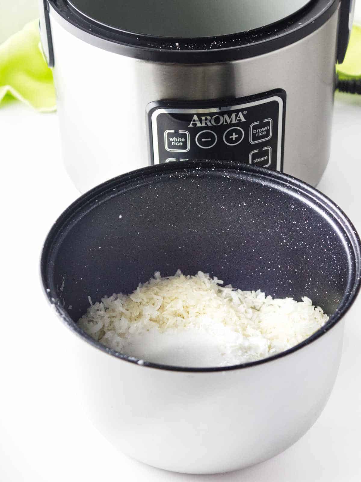 salt, rice, shredded  or flaked coconut added to a pot.