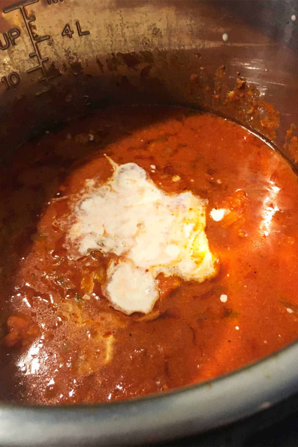 sauce in an pot with cream liaison being added.