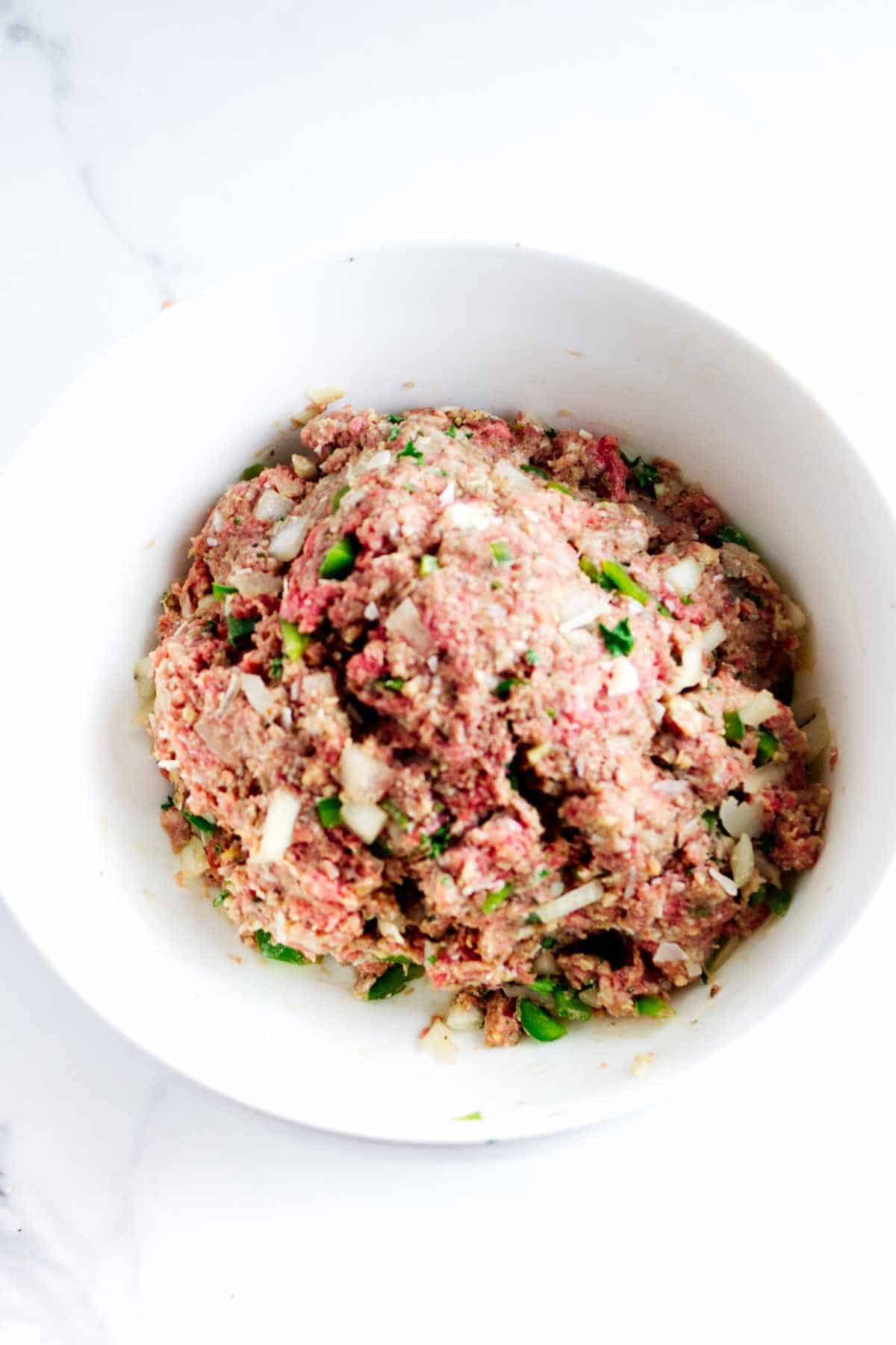 mixed ingredients for meat loaf in a bowl.