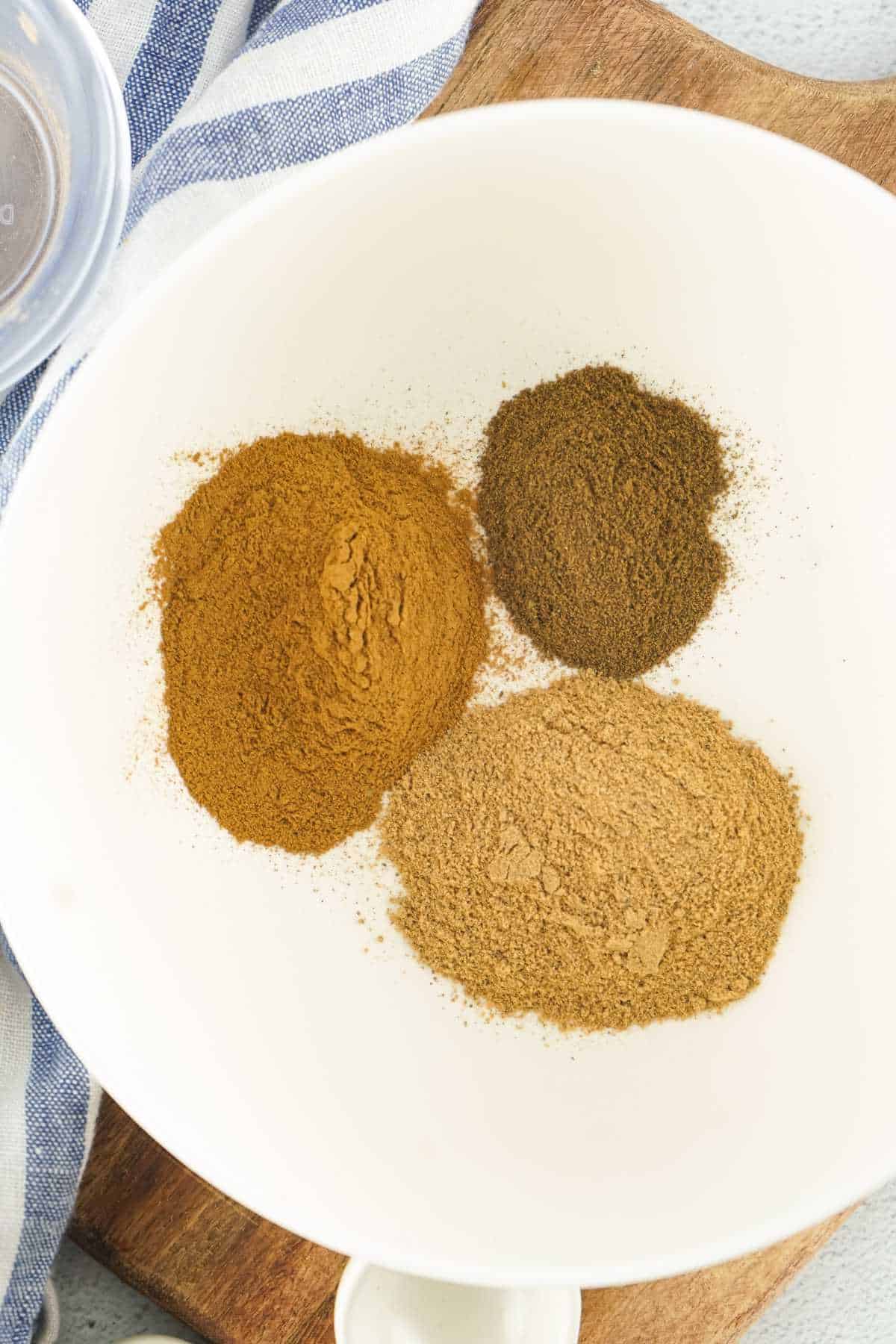 three spice piles in a white bowl.