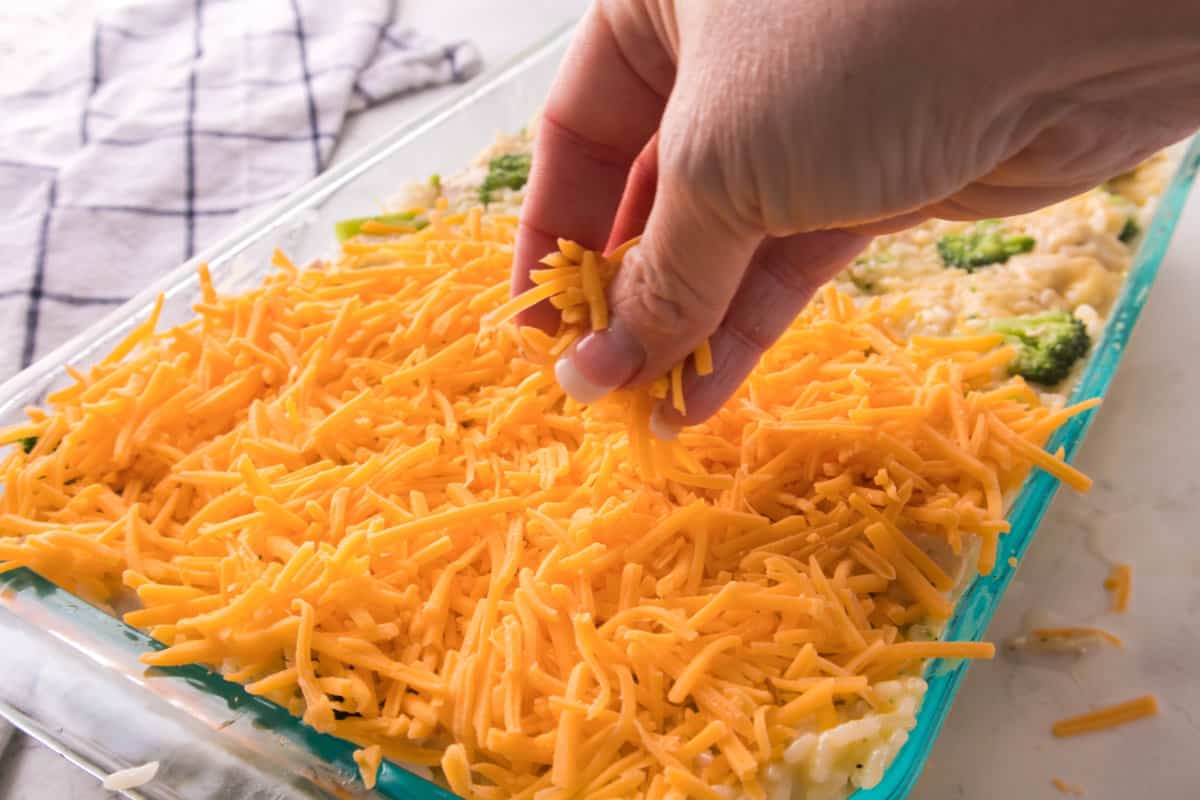sprinkling cheese on top of a casserole.