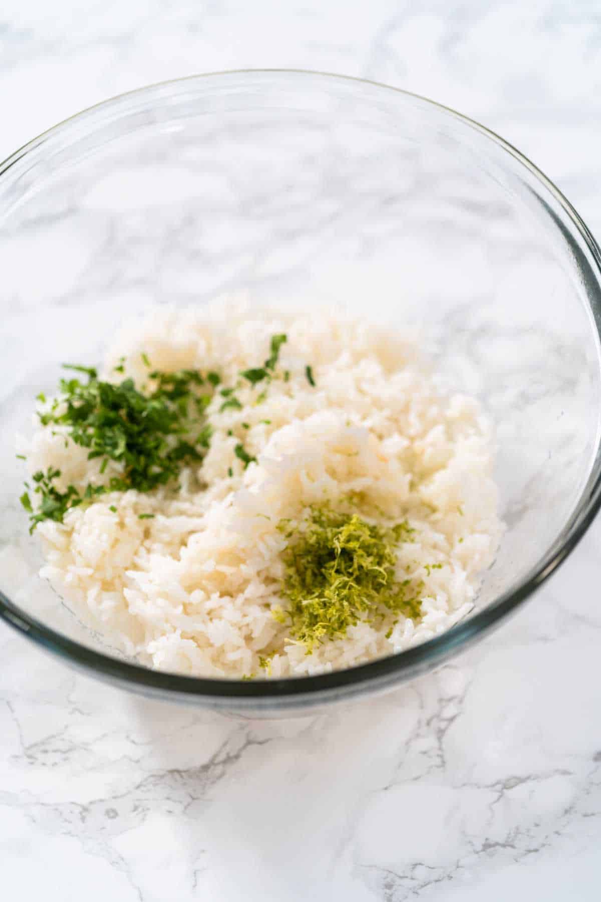 bowl of cooked white rice, chopped cilantro, and lime zest.