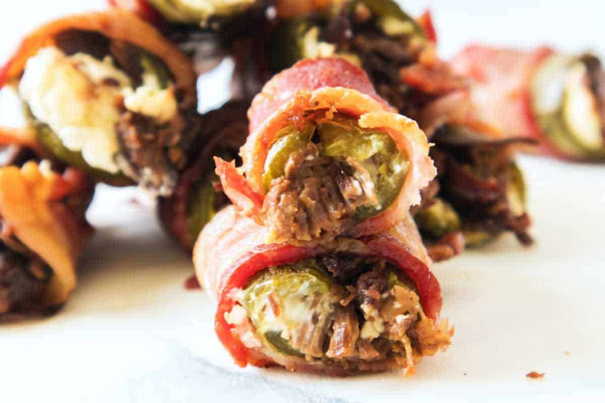 smoked jalapeno poppers on a white background.