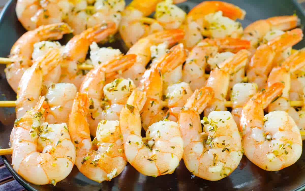 marinated shrimps on wooden skewers.