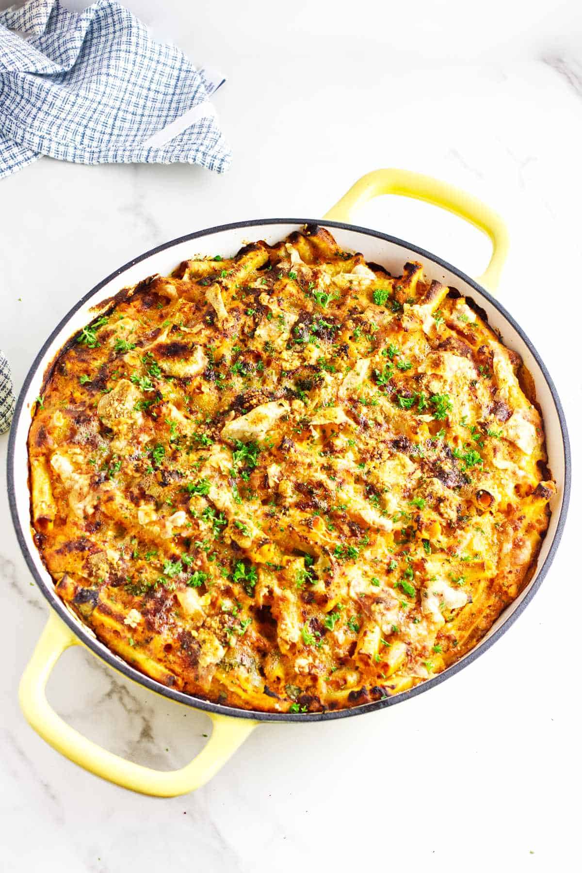 large round casserole full of a baked ziti casserole.