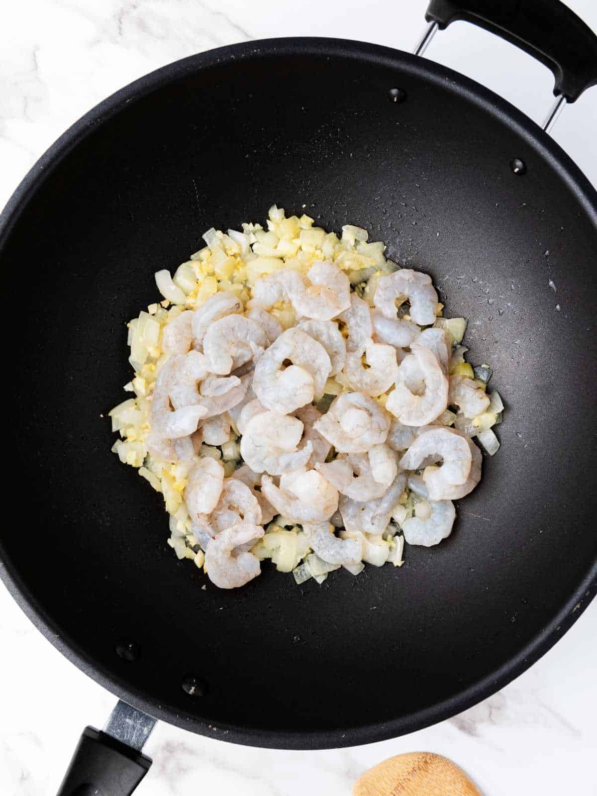sauteed onions and garlic, with raw shrimp added to skillet.