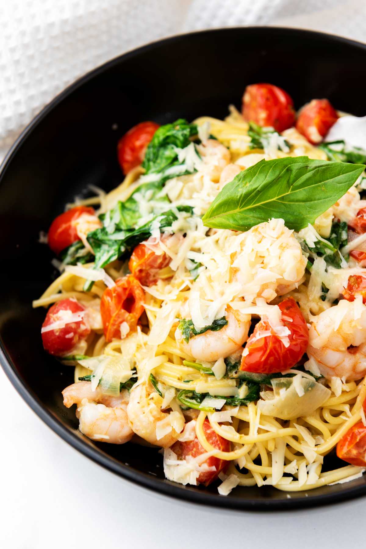 shrimp scampi angel hair pasta tossed with cream sauce, shrimp, tomatoes, and spinach.