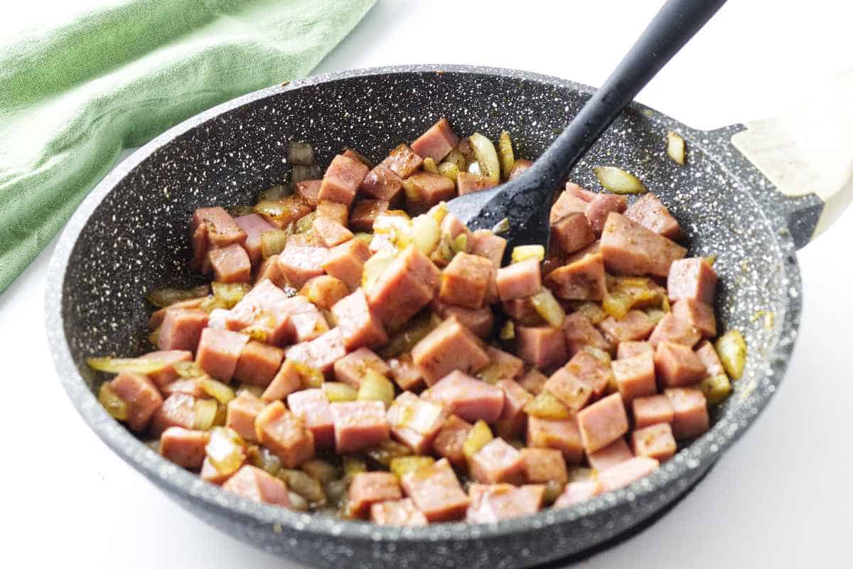 sauteed ham, onions, and garlic in a skillet.