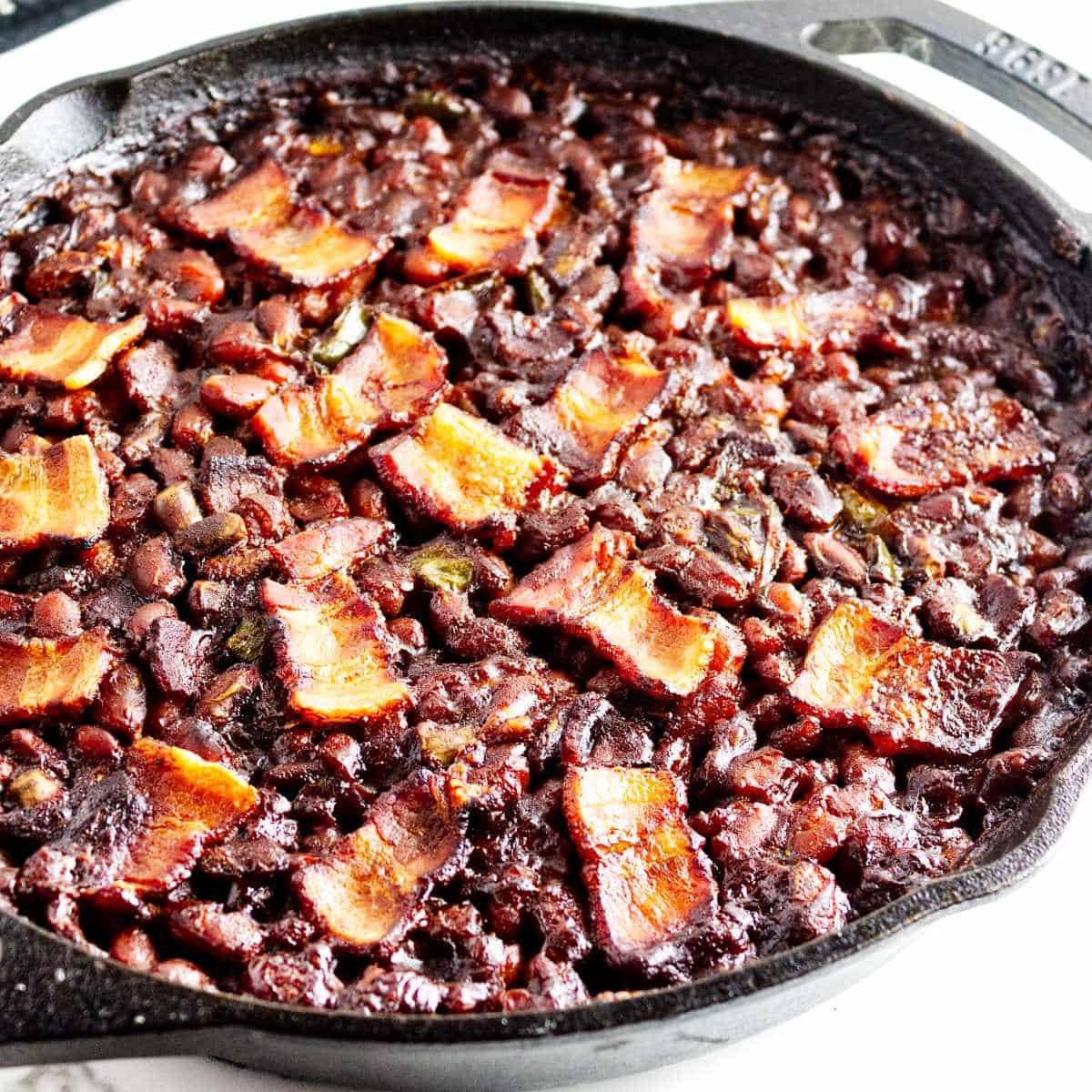 smoked baked beans in a cast iron skillet.