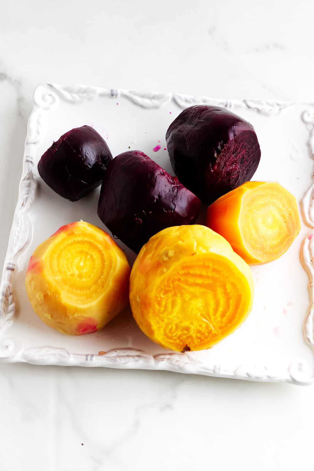 peeled cooked beets on a plate.