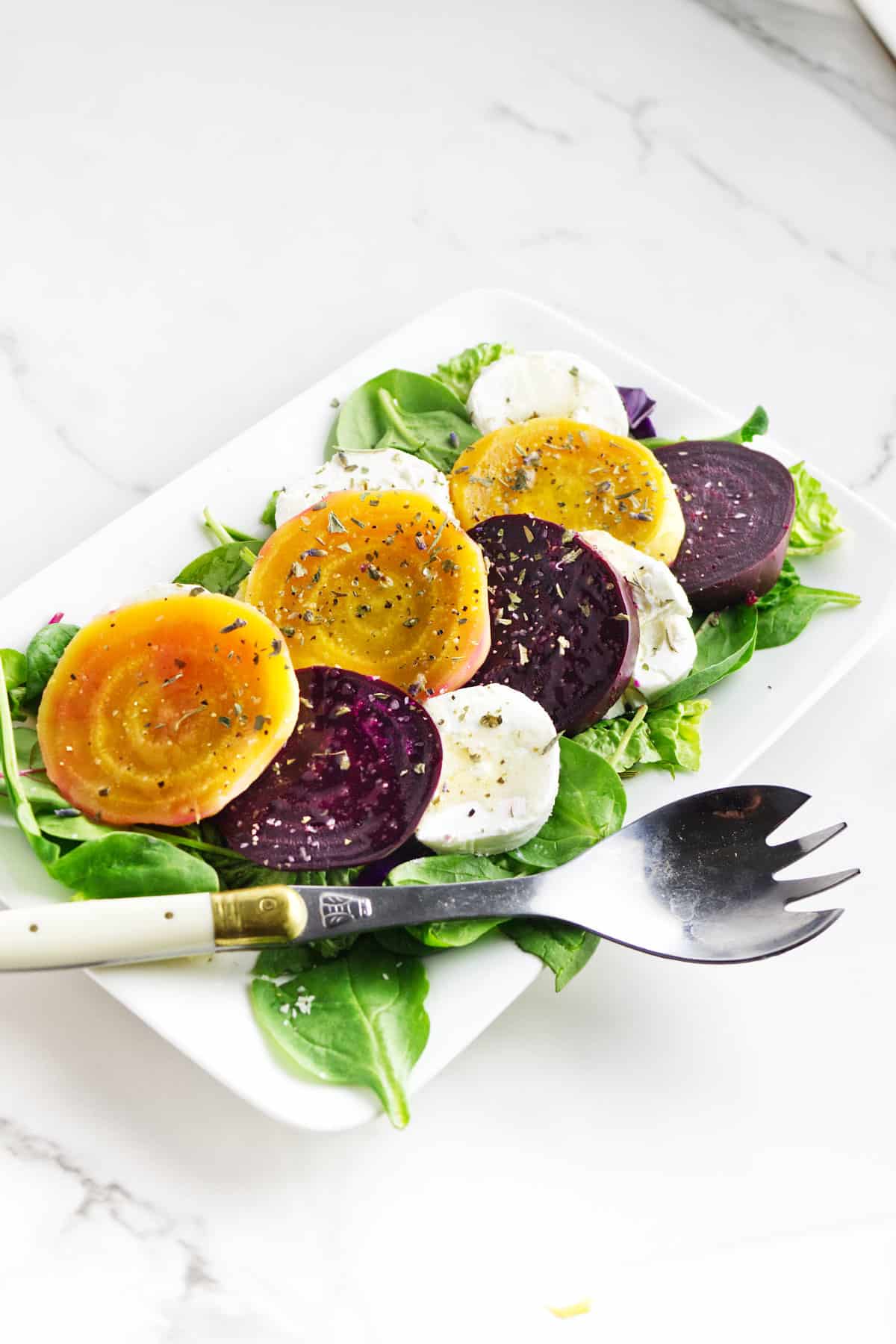golden beets salad on a white platter.