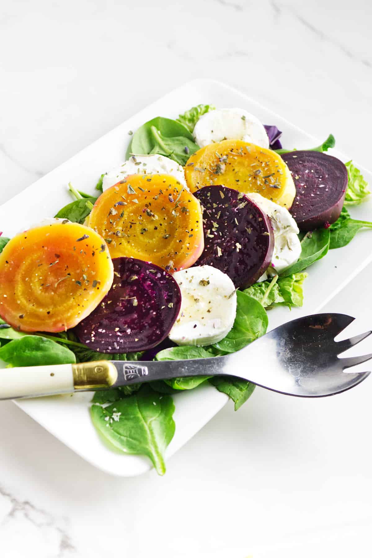 golden beets salad on a white platter.