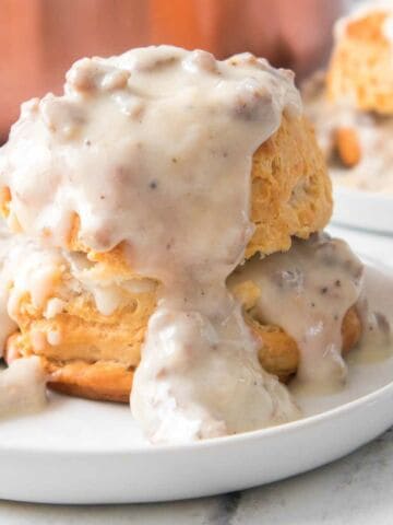 gravy covered biscuit on a plate.