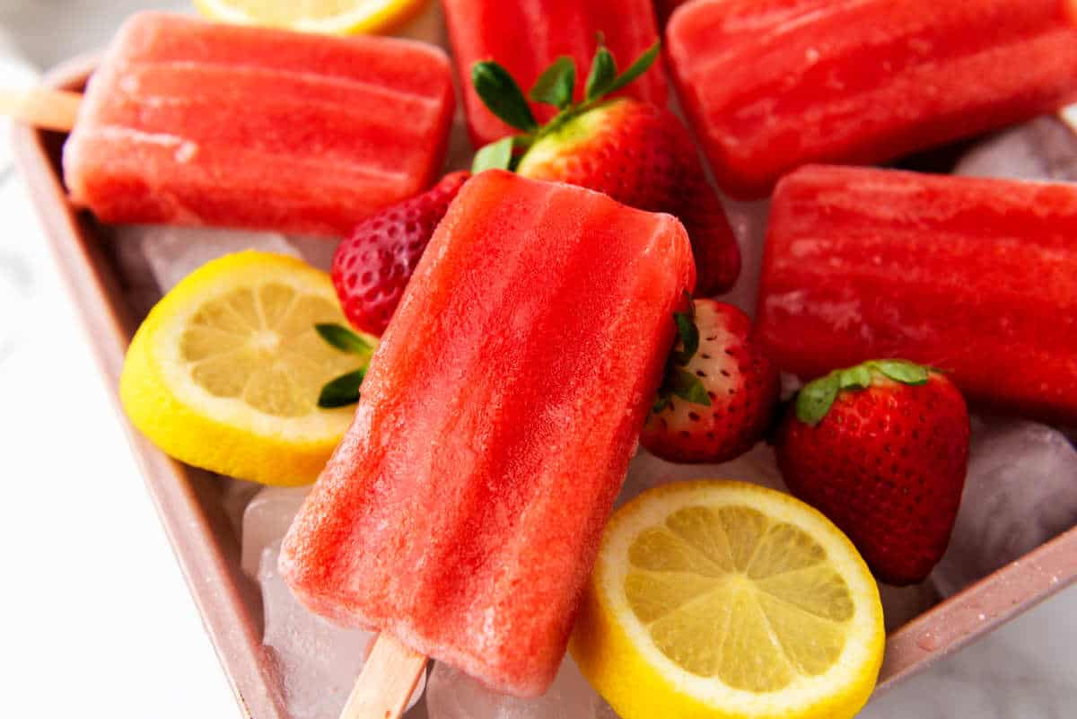 strawberry popsicles on a tray of ice.