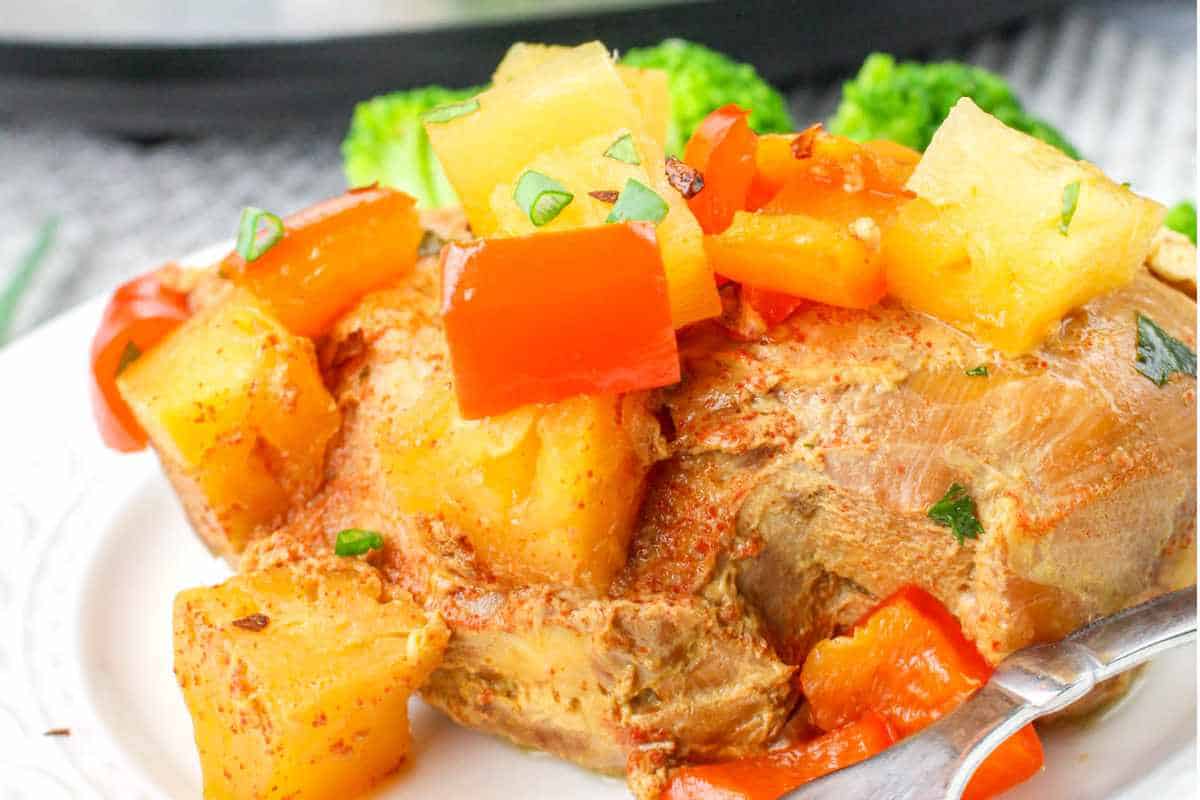 pineapple chicken on a plate with red bell pepper.