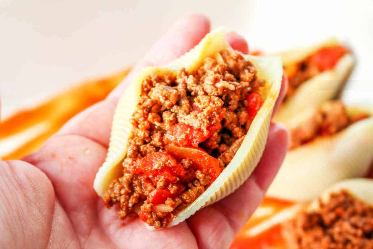 close up of a ground beef taco stuffed pasta shell.