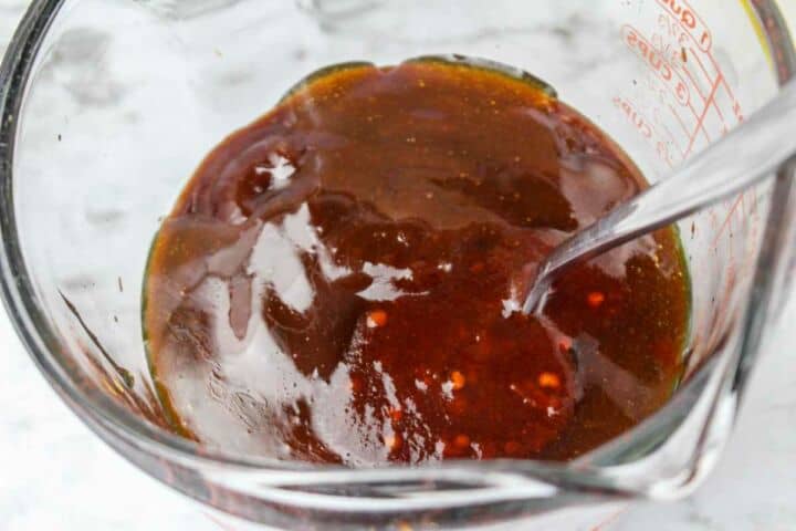Chipotle BBQ sauce, honey, and minced chipotle peppers in a bowl for chipotle glaze.