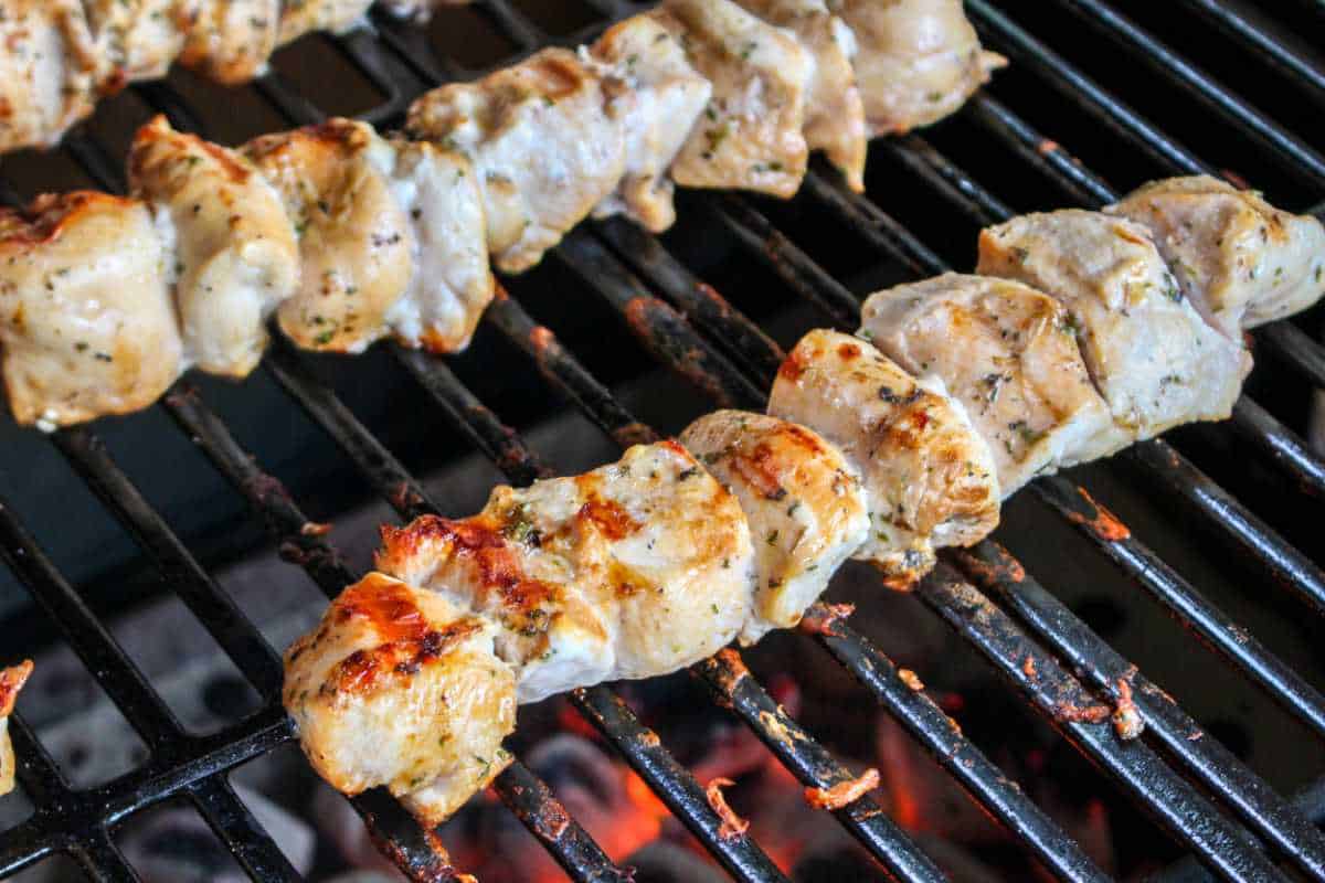 chicken kabobs on a grill.