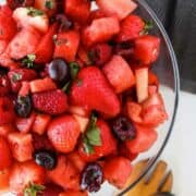 berries and watermelon in a white bowl.