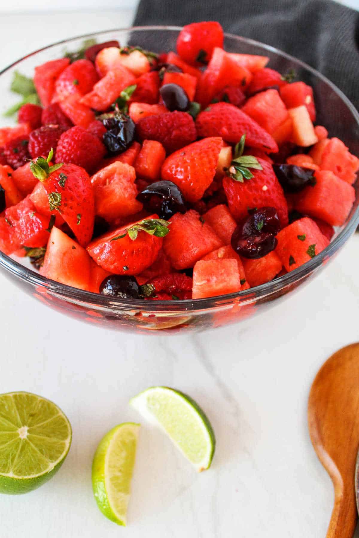 berries and watermelon in a white bowl.