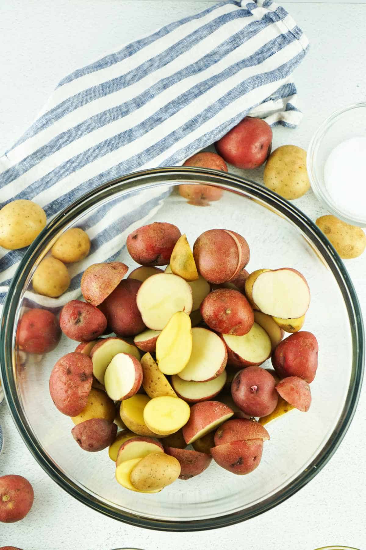 washed and halved potatoes in a bowl.