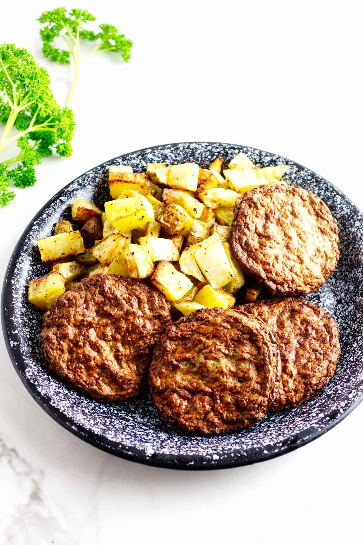 platter of diced potatoes and sausage patties.