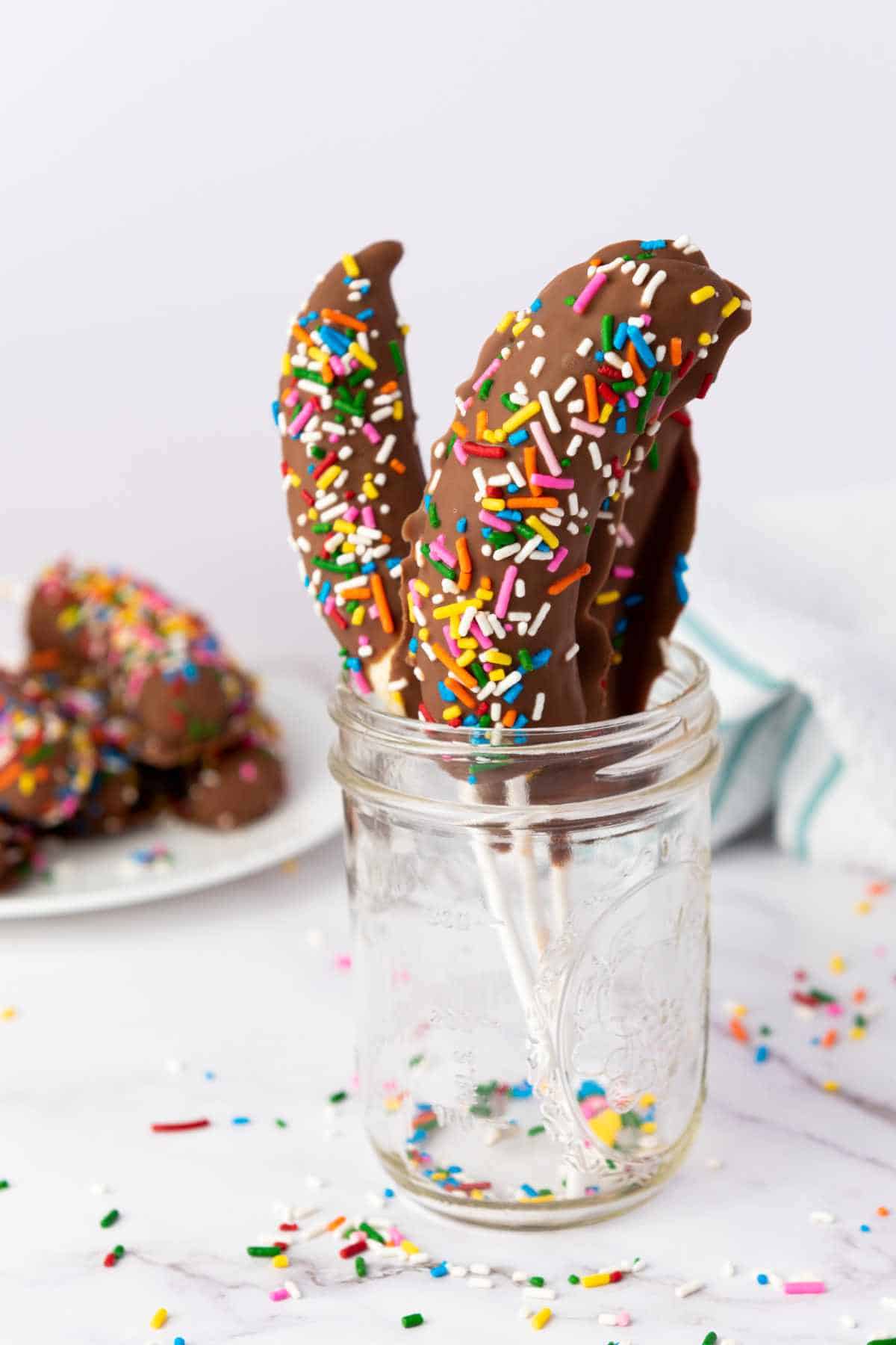 chocolate dipped fruit with colorful sprinkles.