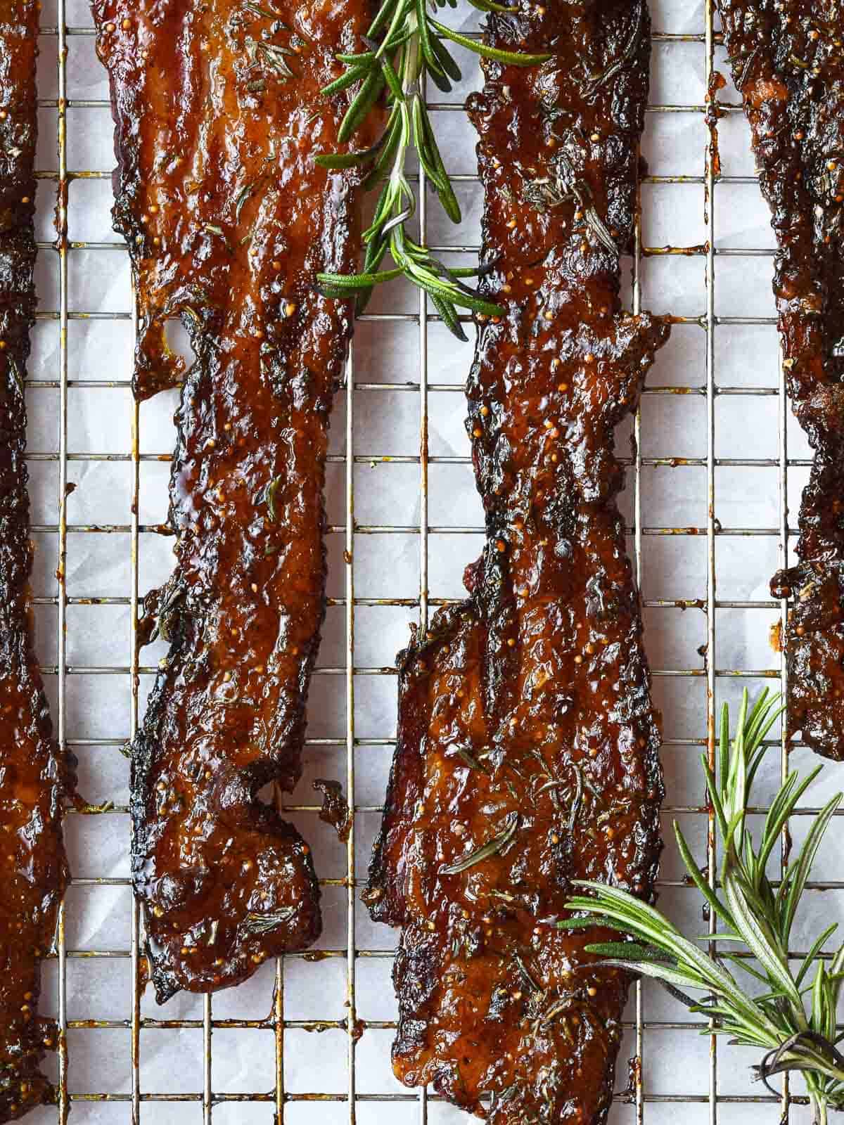 candied bacon cooling on a rack, is an extra special sweet and savory father's day recipe.