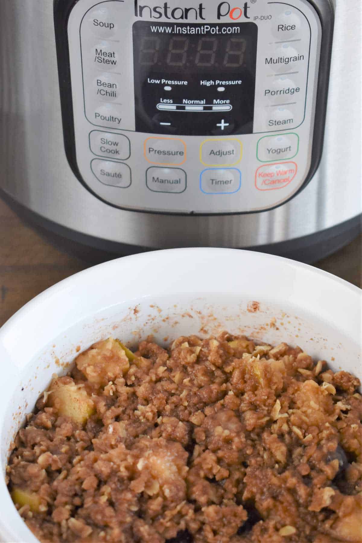 Instant pot with casserole of crumble topped apple and blueberry cobbler.