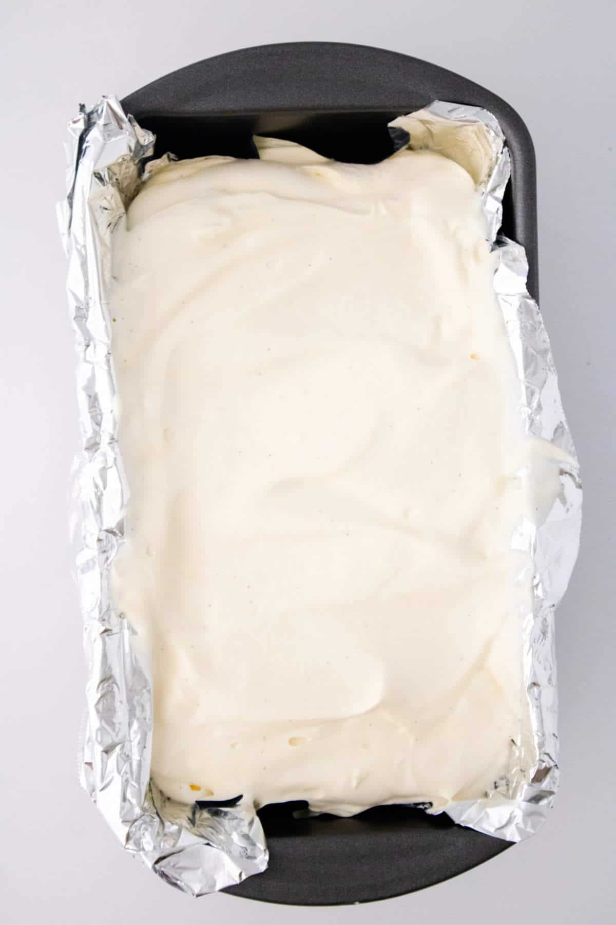 vanilla mixture poured into an aluminum foil lined loaf pan.