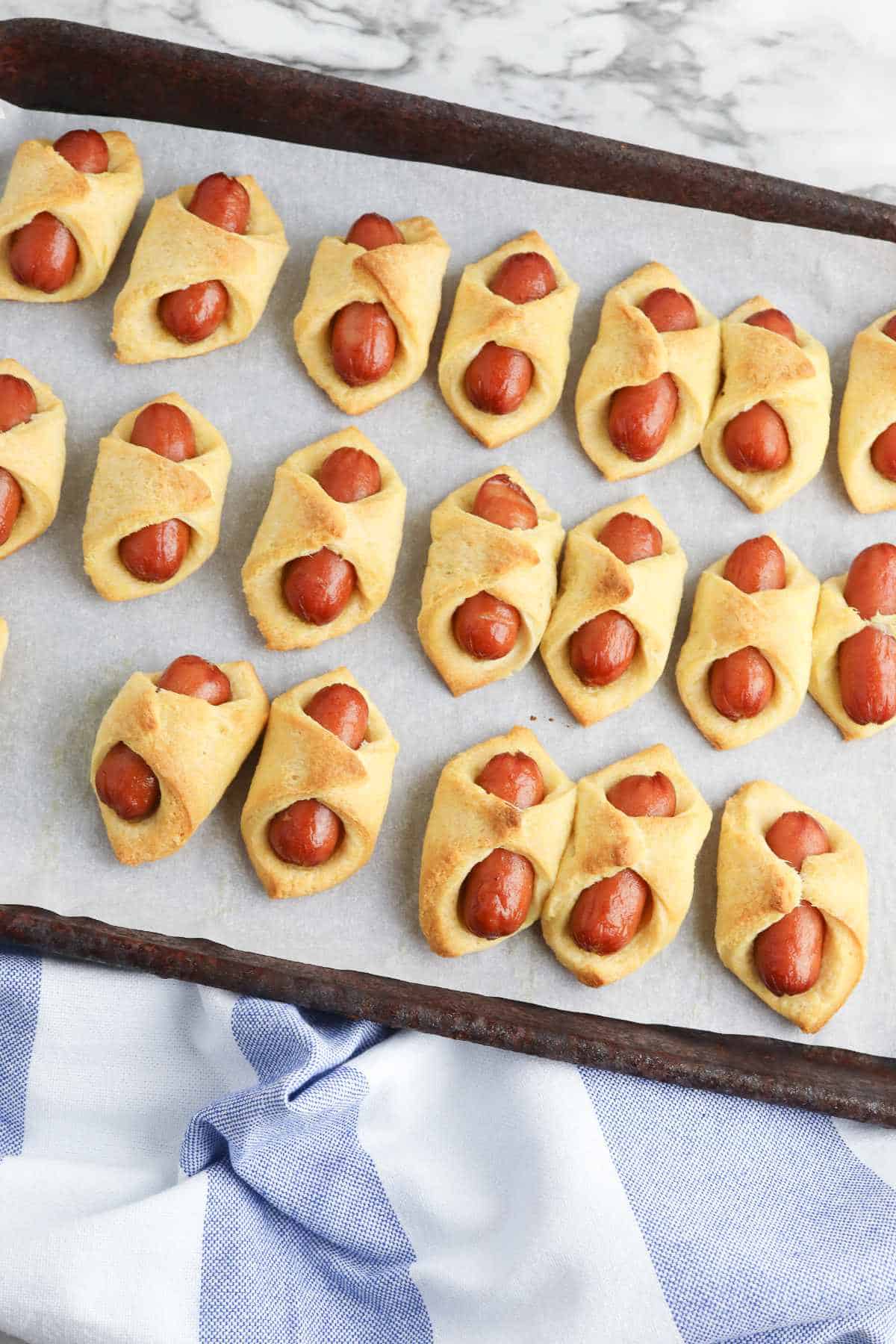 air fryer tray with mini pigs in a blanket on the tray.