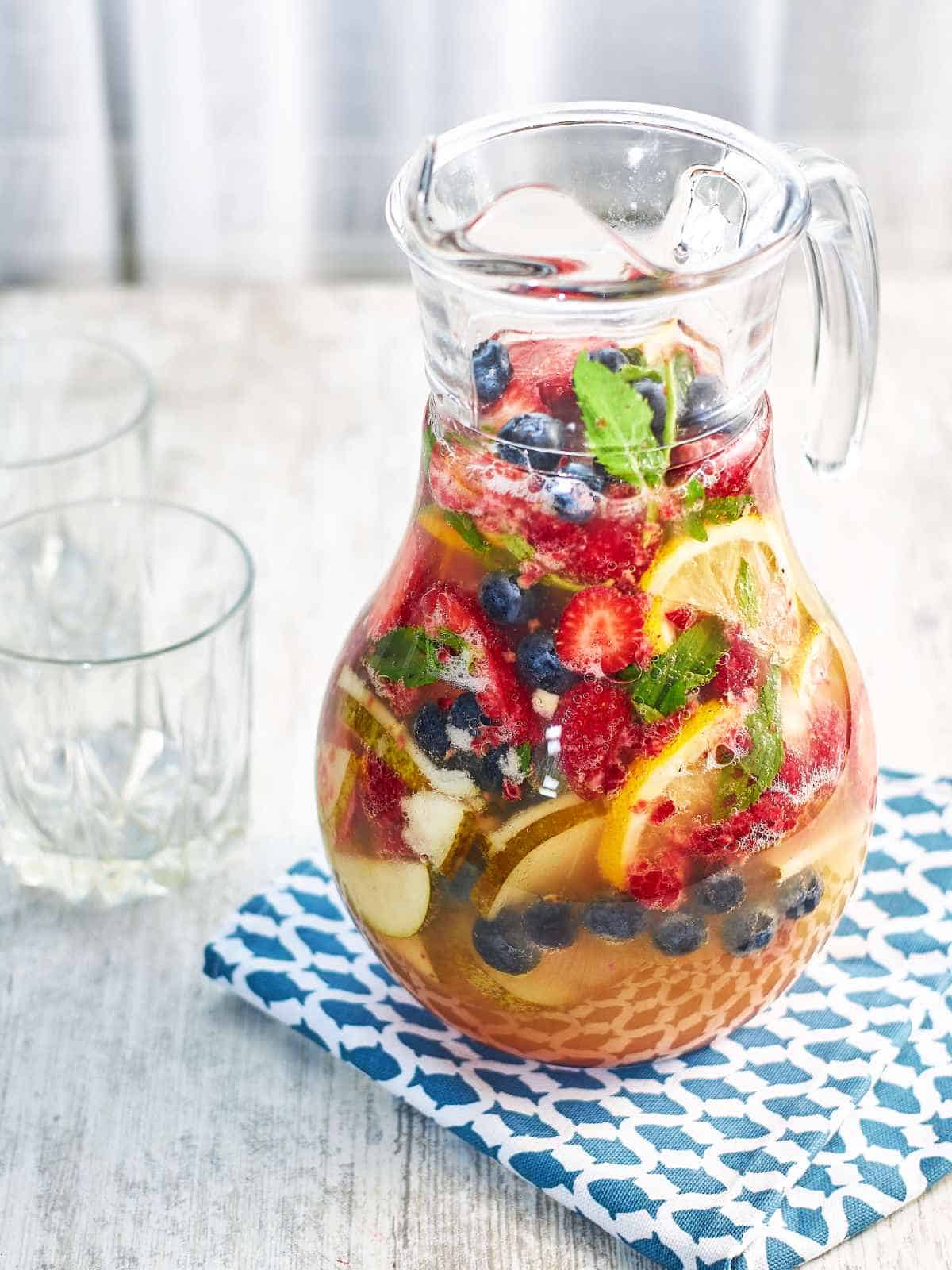 pitcher filled with mint berry fruit and juice sangria recipe white.