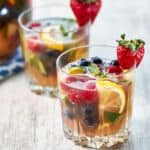 two glasses of blueberries, strawberries, sparkling wing and orange juice brunch sangria.
