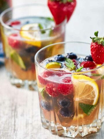 two glasses of blueberries, strawberries, sparkling wing and orange juice brunch sangria.