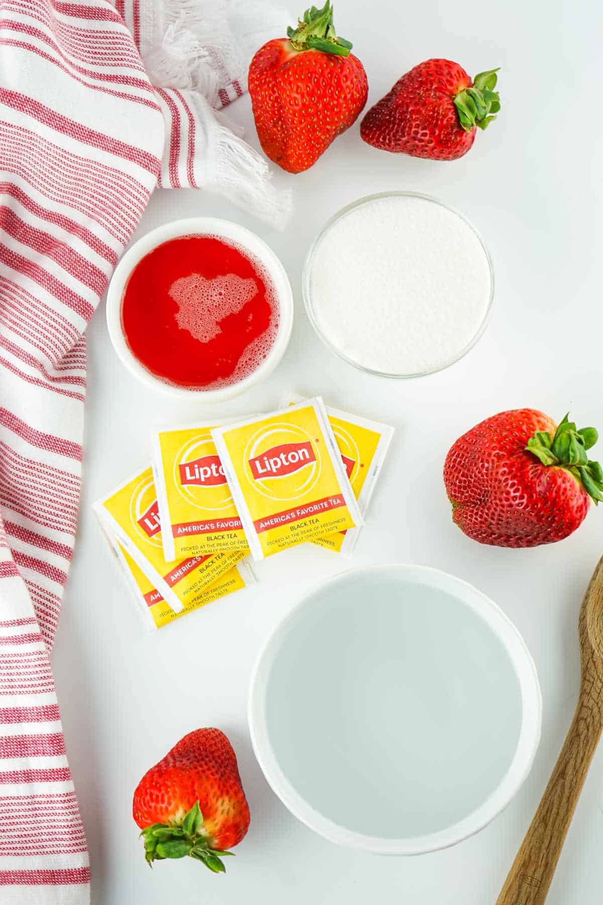 ingredients for making iced tea with strawberry.