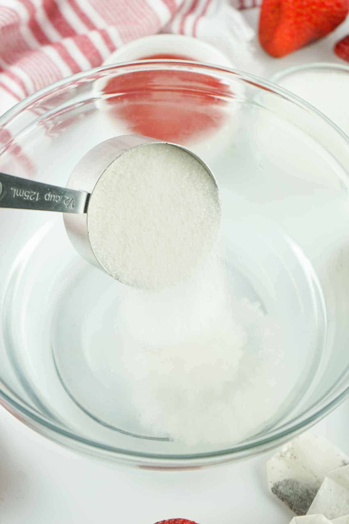 sugar added to boiled hot water in a bowl.