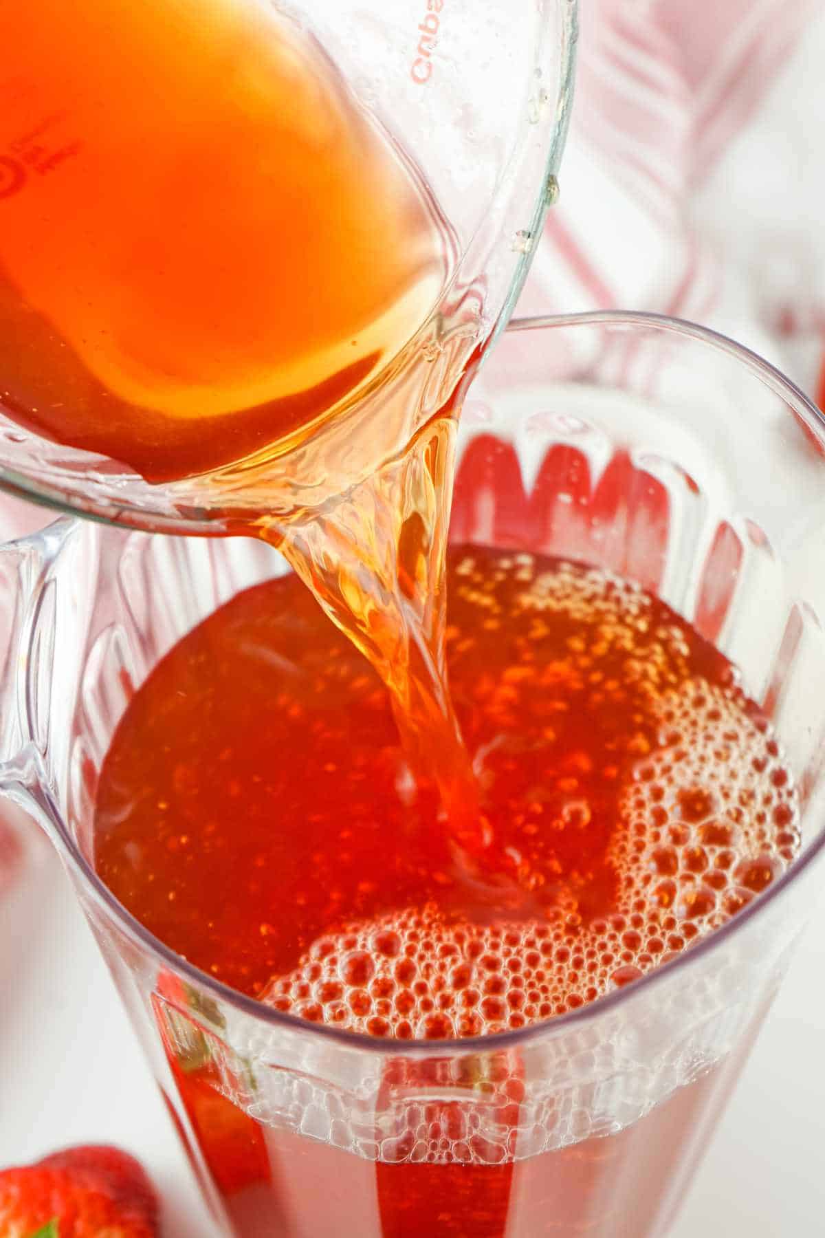 mixed tea and strawberry juice poured into a large pitcher.