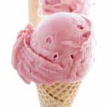 scoop of strawberry ice cream on a cone.