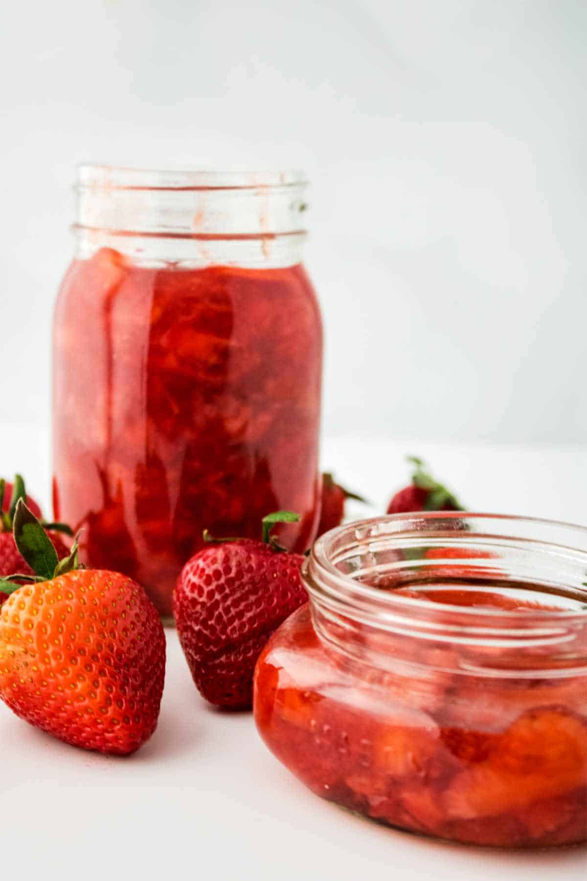 jars of strawberry jam without pectin on a white background.