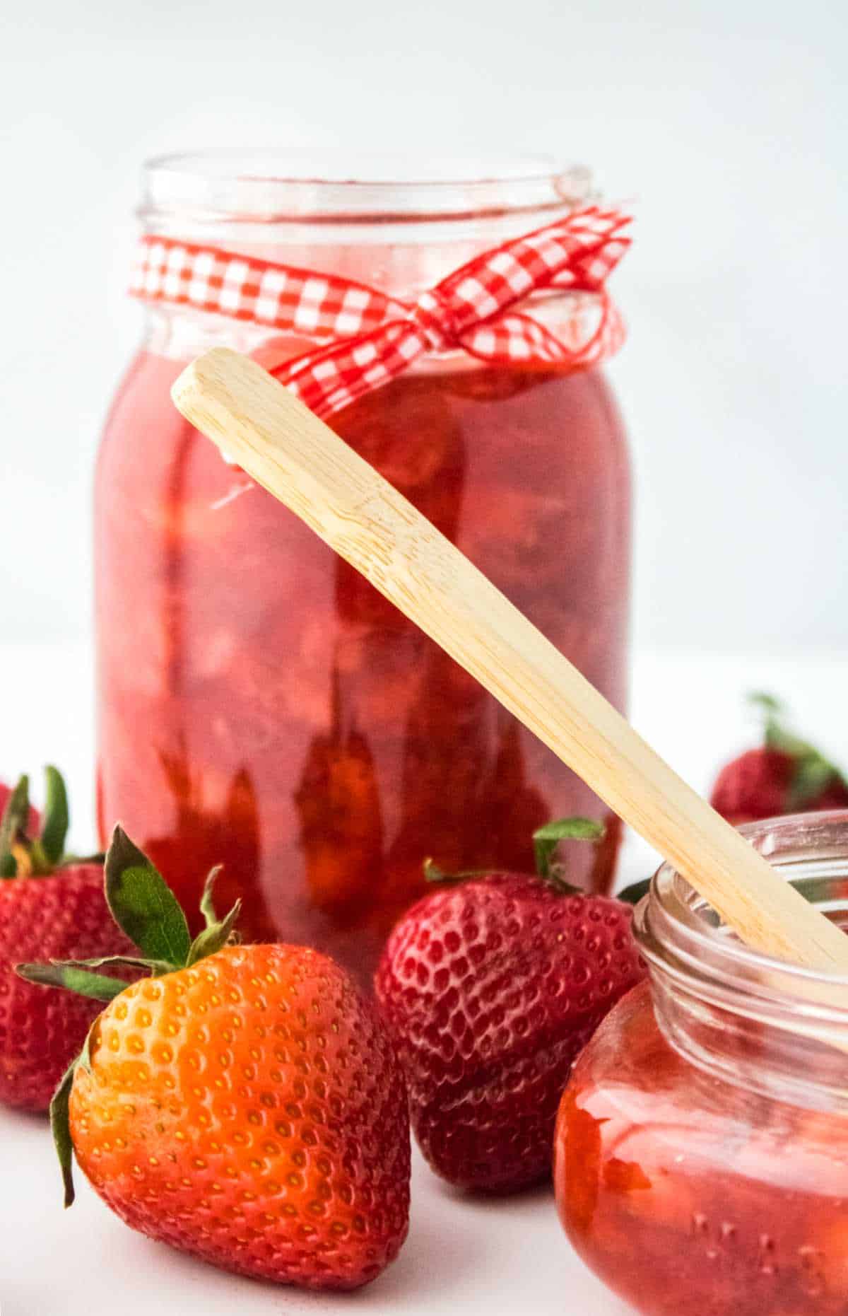 jars of strawberry jam without pectin on a white background.