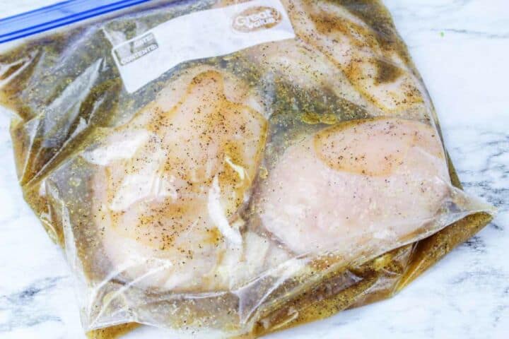 chicken in a Ziploc bag with brine for smoking chicken.