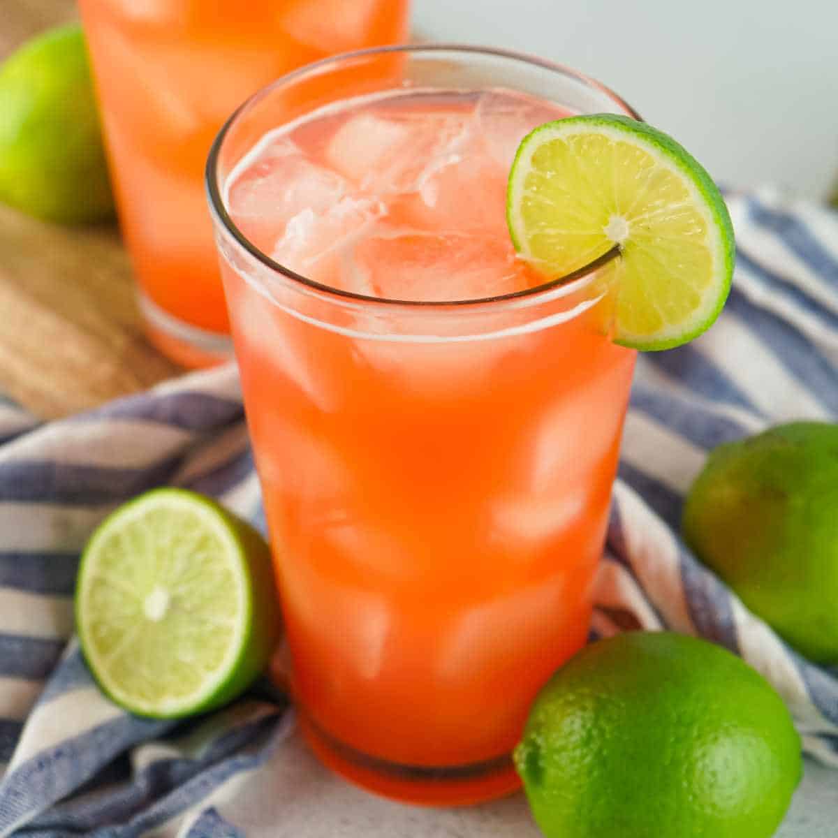 bacardi rum punch in a glass garnished with lime slices.