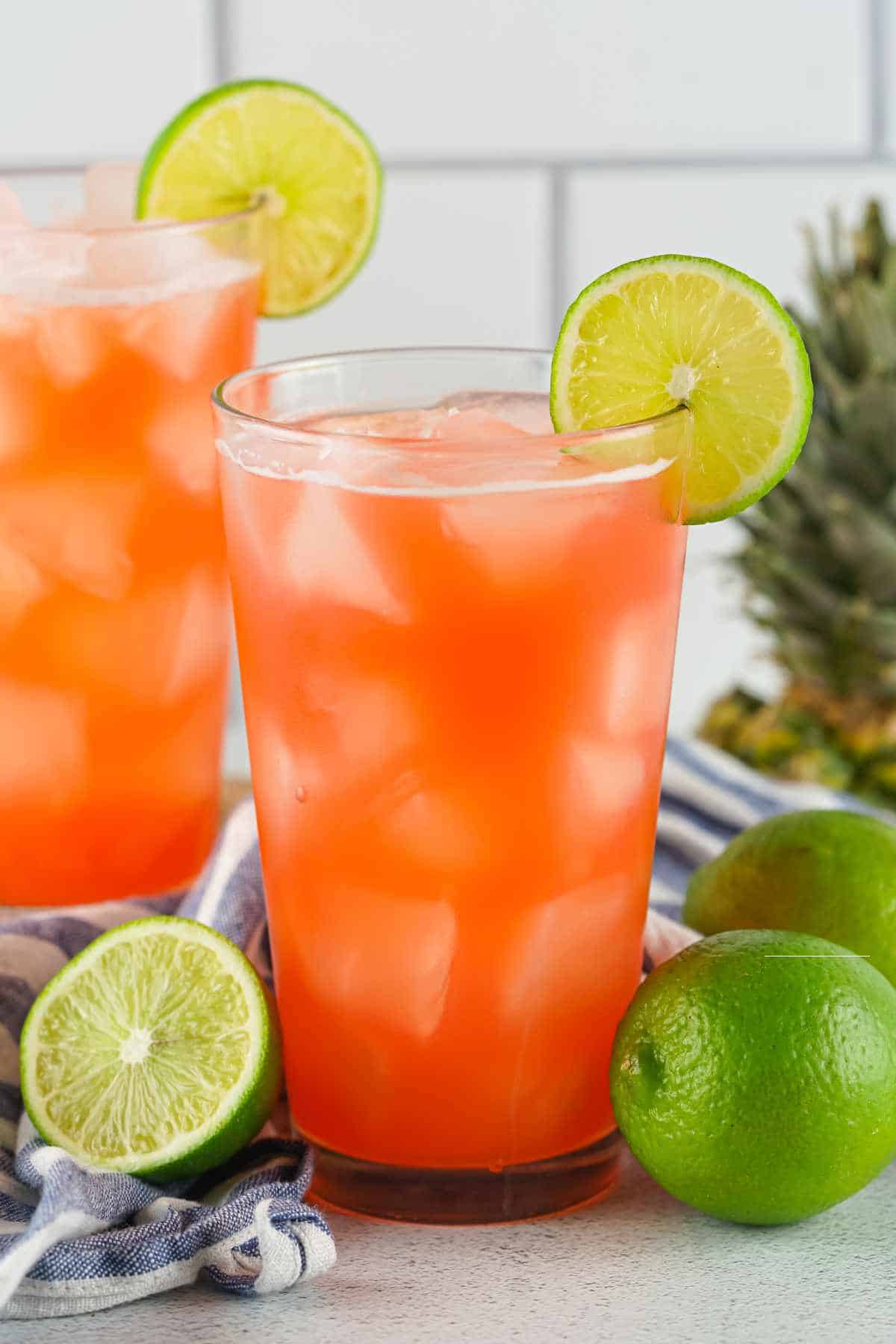 bacardi rum punch in a glass garnished with lime slices.