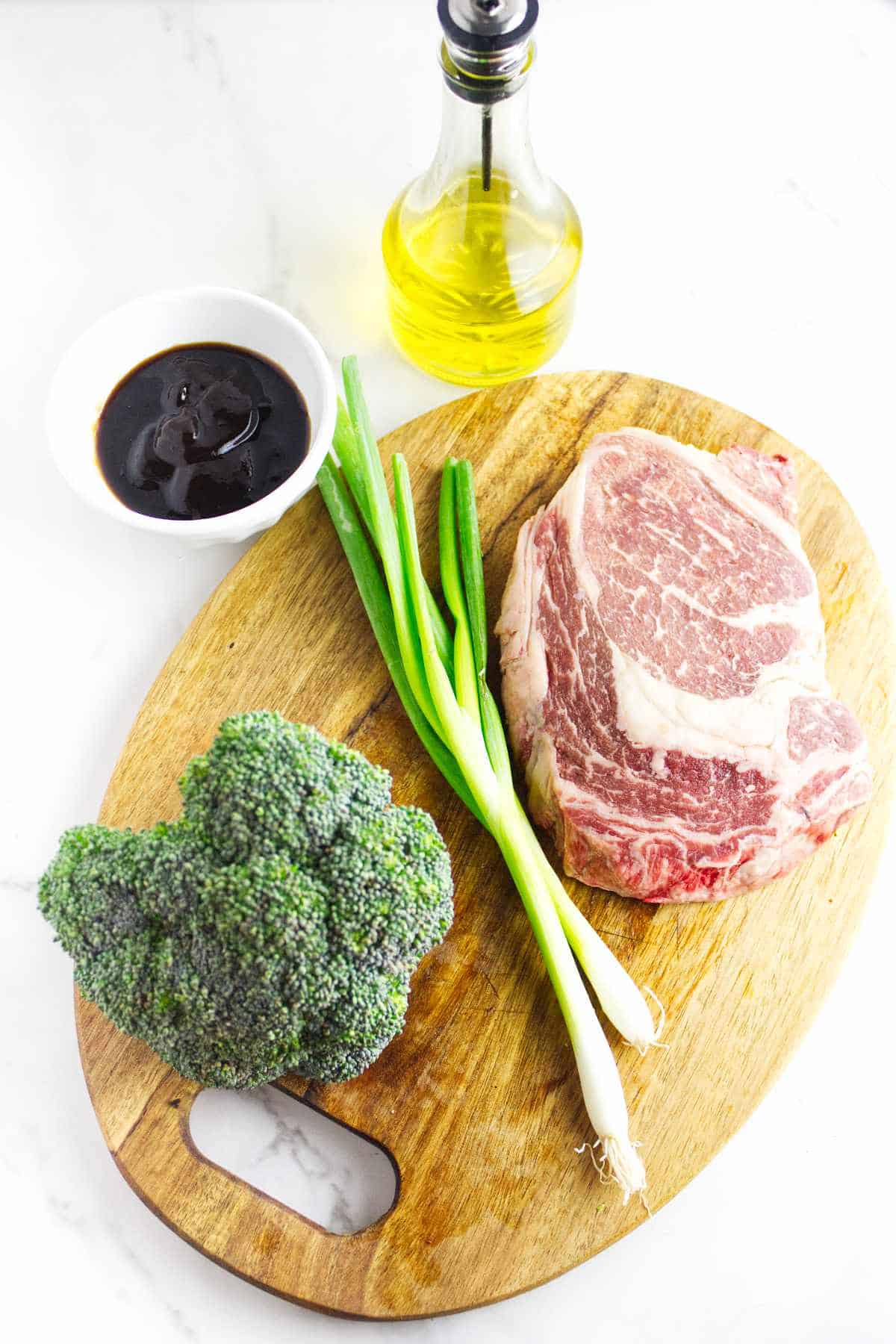 broccoli, green onions, teppanyaki grill sauce, olive oil, andn ribeye steak for blackstone grilling.